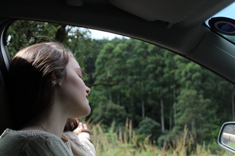 Woman in White Top Inside Vehicle